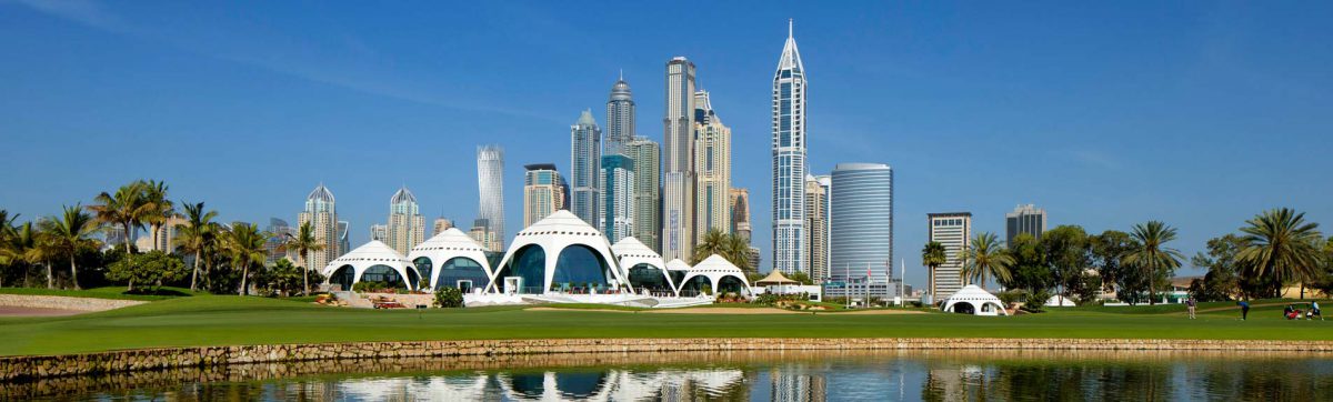 Stunning blue sky day at the Emirates Golf Club in Dubai with eh sky scrapers behind.