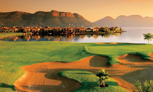 Jack Nicklaus designed Pecanwood Golf Course glows in the early morning sunlight casting reflections of the houses into the lake.