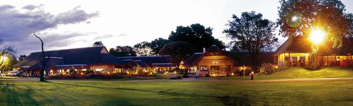 Dusk settles and lights glow at the Hans Merensky club house.