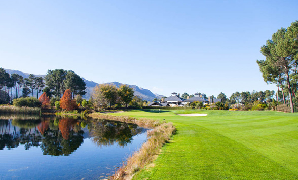 Trees reflected in the lake that lines the fairway at Pearl Valley Golf Club.