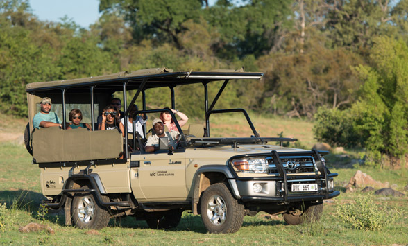 Guests on a game drive vehicle in the Kruger National Park.