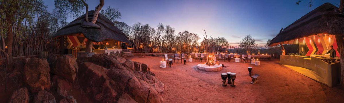 Dining under the stars by a roaring fire in the Madikwe Hills Game Lodge Boma.