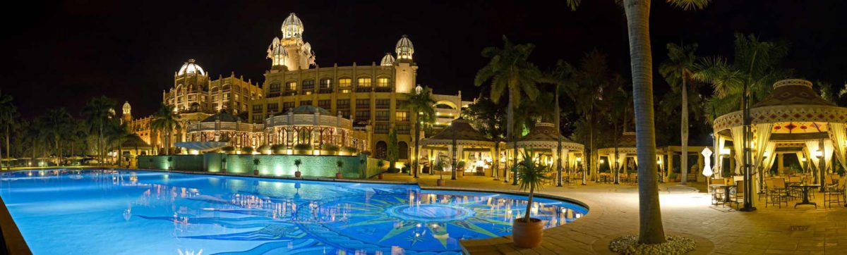 Palace of the Lost City Hotel swimming pool lit up at night.