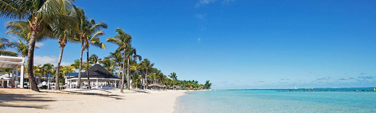 powder white sand beach and azure blue Indian ocean at the the Heritage Le Telfair Hotel.