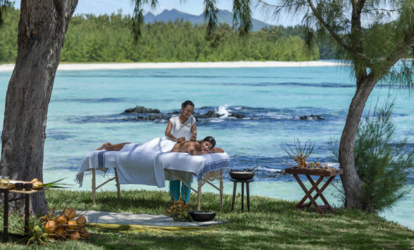 lady having a massage by the ocean.