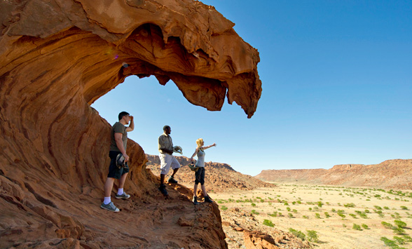 Guests exploring the rock formations in Damaraland with their guide