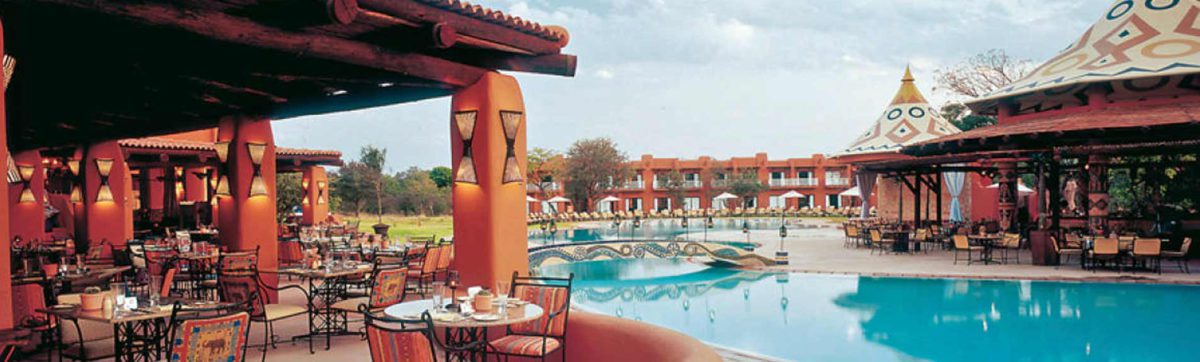 reflections in the swimming pool at the Avani Victoria Falls Hotel.