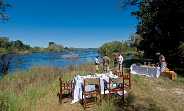 Picnic set up on Livingstone Island overlooking the Zambezi River at Victoria Falls.