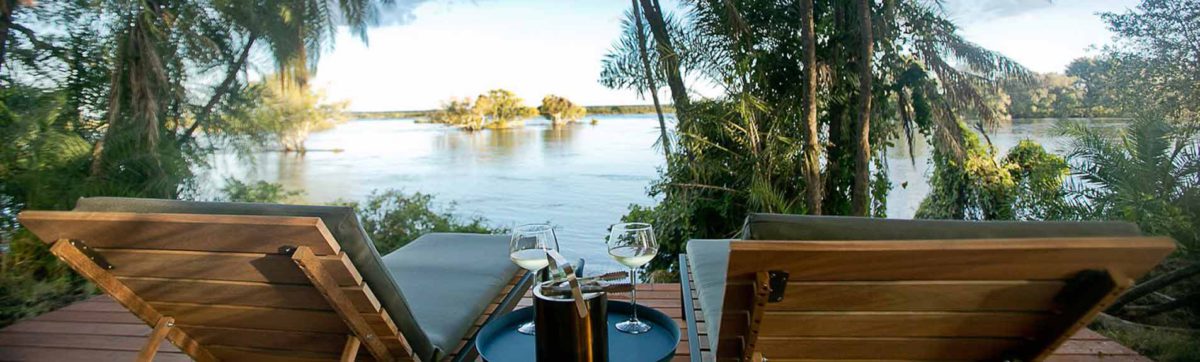 relaxing in sun loungers overlooking the banks of the zambezi river.