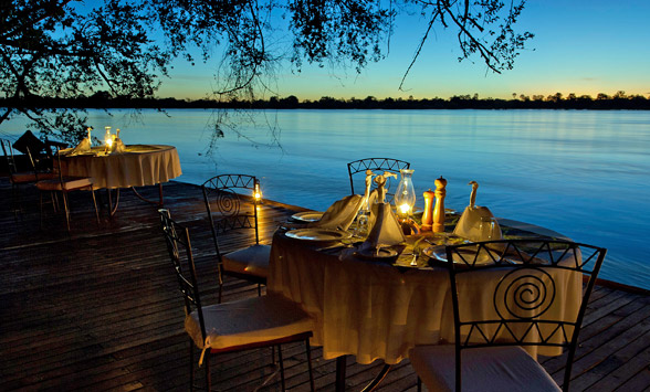 Romantic table setting overlooking the Zambezi River in Zambia.