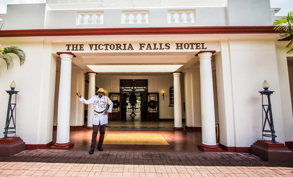 a warm welcome from staff at the entrance to the Victoria Falls Hotel.