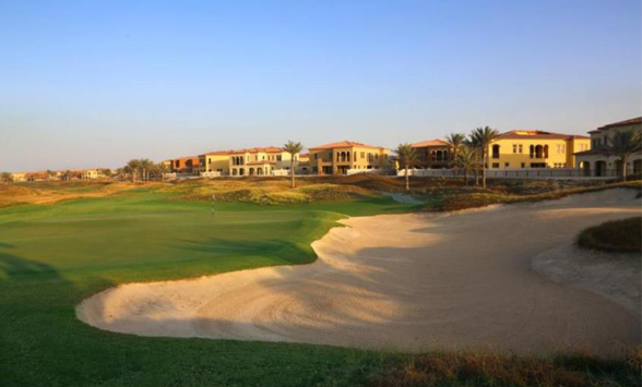 link style golf course with large white sand waste bunkers and the sea beyond.