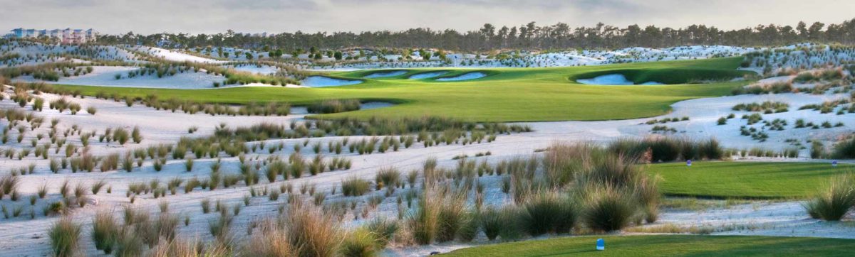 sandy waste bunkers across the fairway at Els Club, Dubai.