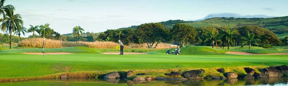 Golfer playing his shot across the fairway at the heritage Golf Club.