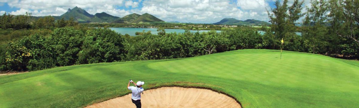 golfer hitting out of a bunker towards the green at Ille aux cerfs