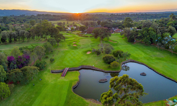 aerial view of the Karen Country Club fairways with the sun setting over Nairobi City.